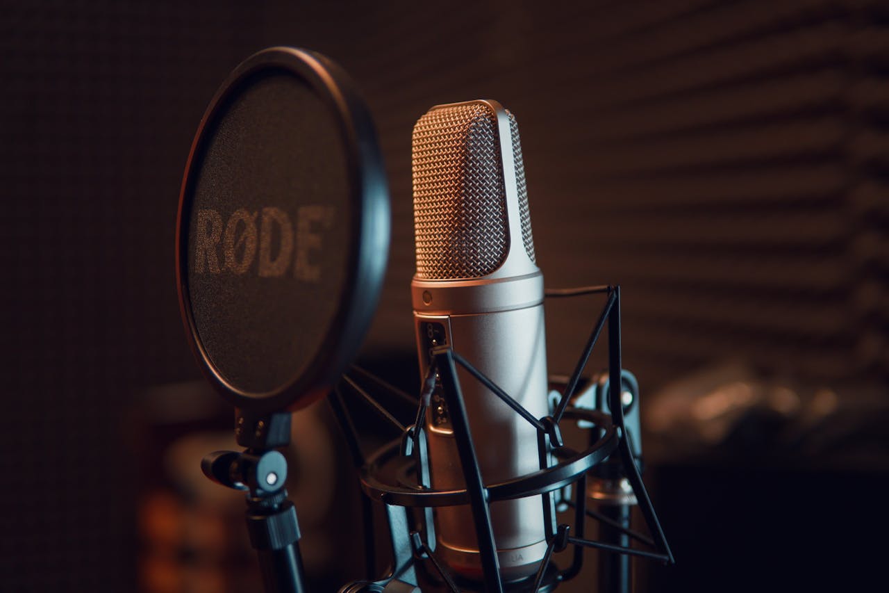 Close-up of a studio microphone with pop filter, ideal for recording audio.